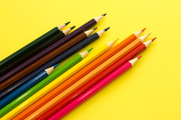 Collection of colored pencils on a yellow background top view. Education, Back to school. Concept