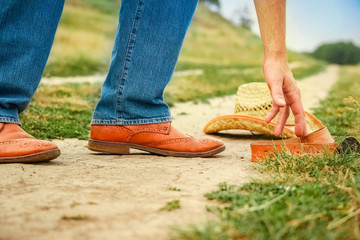 beautiful hands of a cowboy's legs in the park on nature