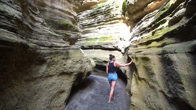 A woman walks through Hell's Gate Canyon in Kenya, East Africa.
