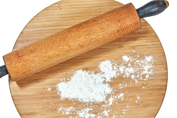 Wooden Rolling Pin on a Cutting Board with Flour