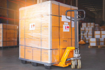 yellow hand pallet truck with goods pallet shipment 