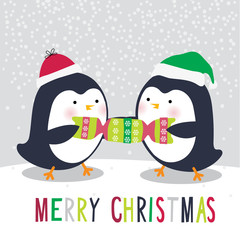 Cute two penguins are pulling the cracker on Christmas day