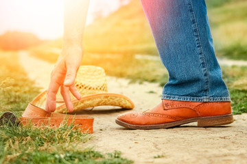 beautiful hands of a cowboy's legs in the park on nature
