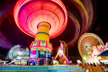 Carnival rides all lit up at night