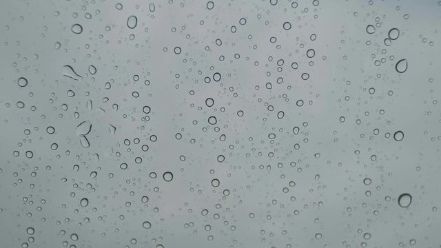 Abstract raindrops on car windshield slow motion