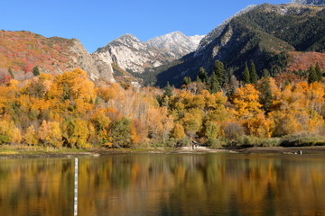 Snowcapped Wasatch Mountains and peak fall foliage at Bells Canyon Reservoir, Sandy, Utah