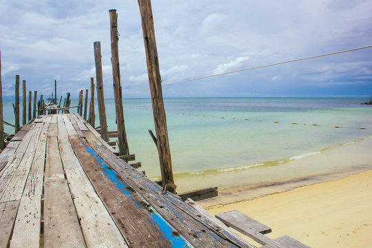 Wood bridge on beach with beautiful sky