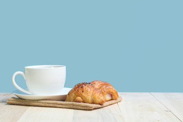 Croissant and coffee   on wood table