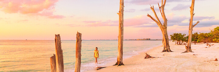 Beach sunset paradise vacation dream tourist lifestyle woman walking on shore banner panoramic background. Woman relaxing in Lovers key, South west coast of Florida, USA travel. - obrazy, fototapety, plakaty
