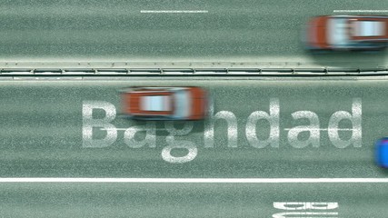 Aerial top-down view of the road. Cars reveal Baghdad text. Travel to Iraq conceptual clip