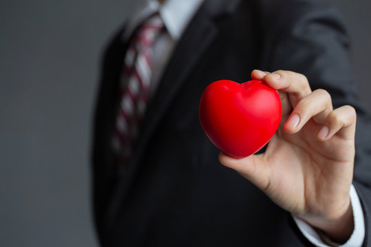 Businessmen holding a red heart.customer relationship management