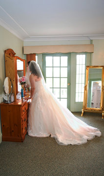 bride in white wedding dress getting ready 