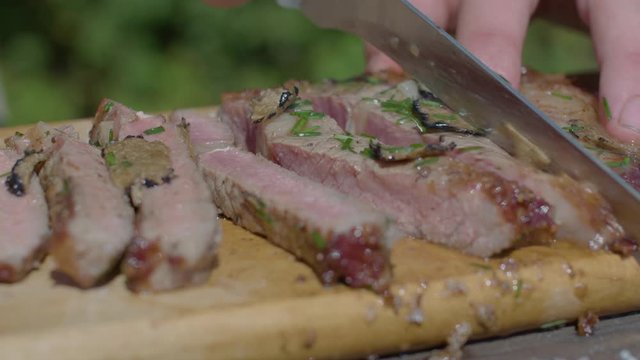 Cutting this amazing ribeye steak made on cast iron skillet over the coals in the forest.
