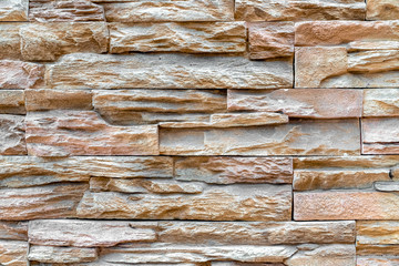 Pattern of stacked stone wall or brick wall texture background.