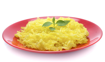 yellow noodles on dish isolated on white background