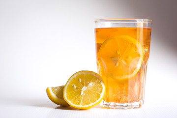 Glasses of ice tea with lemon slices and mint on white background