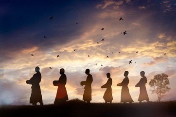 Silhouette Monks alms in the morning,Thailand