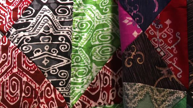 Extreme close-up  low-angle tilting shot of multicoloured, irregular sewed wax painted batik fabric pattern, KL, Malaysia