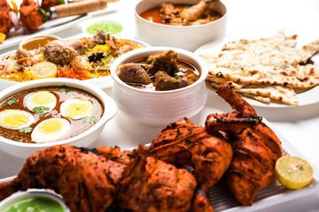 Assorted Indian Non Vegetarian food recipe served in a group. Includes Chicken Curry, Mutton Masala, Anda/egg curry, Butter chicken, biryani, tandoori murg, chicken-tikka and naan/roti