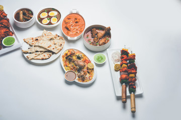 Assorted Indian Non Vegetarian food recipe served in a group. Includes Chicken Curry, Mutton Masala, Anda/egg curry, Butter chicken, biryani, tandoori murg, chicken-tikka and naan/roti
