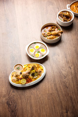 Assorted Indian Non Vegetarian food recipe served in a group. Includes Chicken Curry, Mutton Masala, Anda/egg curry, Butter chicken, biryani, tandoori murg, chicken-tikka and naan/roti
