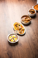 Assorted Indian Non Vegetarian food recipe served in a group. Includes Chicken Curry, Mutton Masala, Anda/egg curry, Butter chicken, biryani, tandoori murg, chicken-tikka and naan/roti
