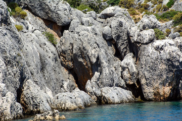 Mediterranean Sea. Coastal cliffs with stone structure with traces of time. Concept - time frozen in stone