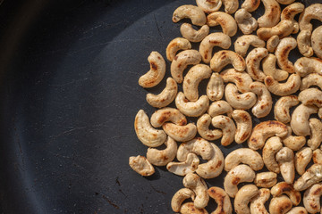Close-up Roasted cashew nuts and  salt in a pan.Concept Health.