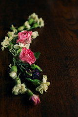 Dried Flowers Composition on a brown wood table, Greeting card, Rose and carnation composition, Close up shot, Flat lay, top view, copy space.