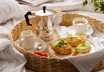 Fototapeta na wymiar Breakfast in bed in hotel room. A romantic breakfast for your beloved