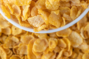 Cornflakes in bowl, a delicious and healthy dietary breakfast cereal. Selective Focus. Top View