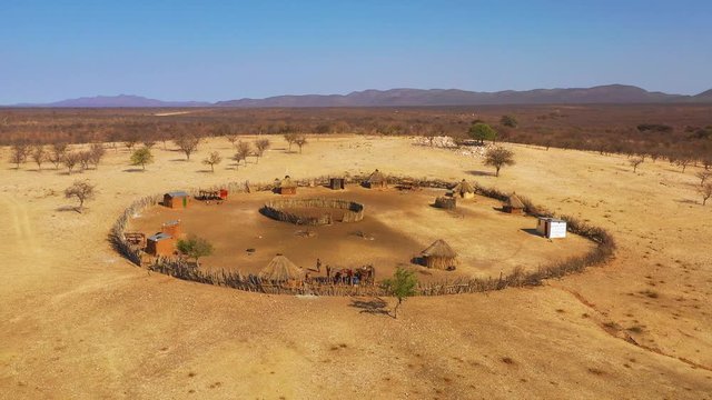 Beautiful aerial over a round Himba African tribal settlement and family compound in northern Namibia, Africa.