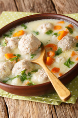 Traditional bulgarian soup with meatballs close-up in a bowl on the table. vertical