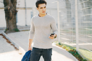 stylish man walking through the city by himself