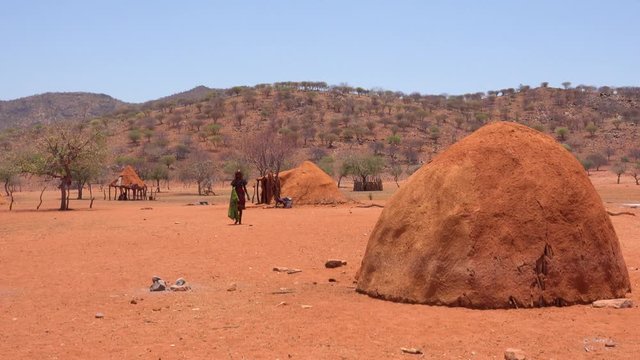 Small poor African Himba rural village on the Namibia Angola border with mud huts, goats and children.