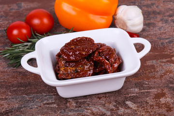 Dried tomatoes in the bowl with olive oil