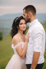Beautiful wedding couple in Carpathian mountains. Handsome man with attractive woman