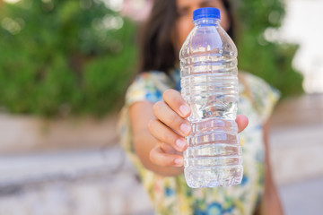 Close-up of water bottle on the street