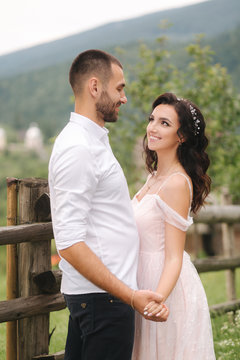 Lovestory of beautiful couple in the mountains, Handsome bearded man with beautiful and charming woman