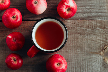 top view apple drink in a red cup and ripe red apples on a wooden background copy space