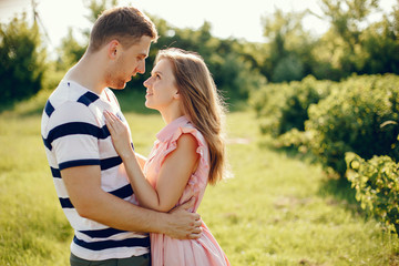 Couple in a field. Girl in a pink dress. Man in a white shirt