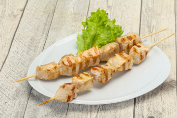 Grilled pork skewer served salad