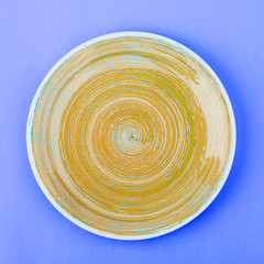 Light beige plate on the saturated blue background