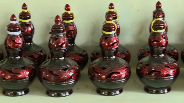 Close-up high-angle panning shot of hand-made, glossy painted traditional Labu Sayong souvenir gift containers, Perak Pottery, Kuala Lumpur, Malaysia