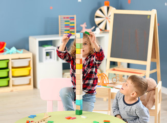 Cute little children playing in kindergarten