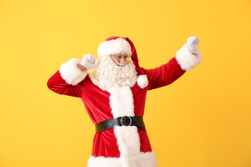 Portrait of cool dancing Santa Claus on color background