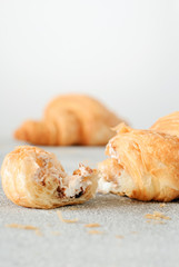 Slices of crispy croissant with plum jam.