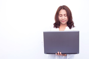 Beautiful woman holding a laptop while posing against a white background