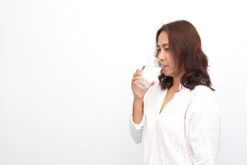 Portrait of a young woman drinking water on white background