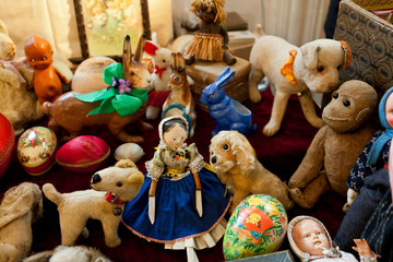 group of vintage dolls and ancient plush animals